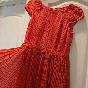 Coral and black polka dot pleated dress